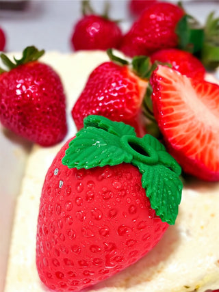 Custom red INTAKE vibrator displayed on white bedding for sensual presentation