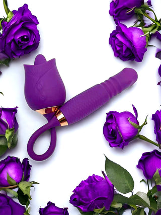 Dual-ended licking and thrusting rose vibrator held in hand against a purple background