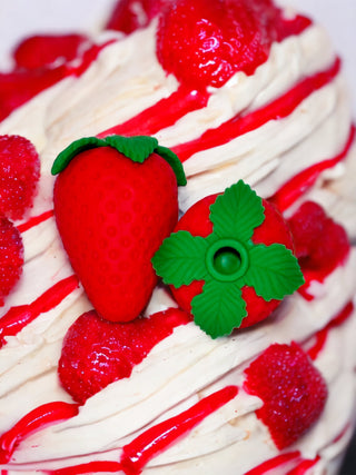 Luxury G-spot toy Strawberry Bliss shown in romantic bedroom setup