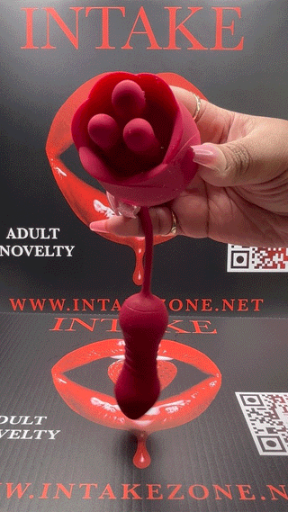 Hand holding The Ultimate Rose vibrator against INTAKE packaging with lips logo