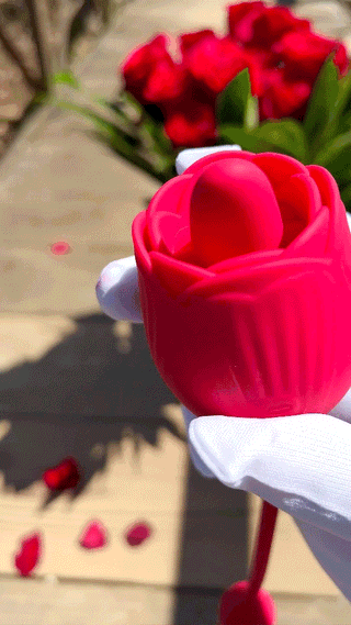 Close-up of The Ultimate Rose Many Licks Thruster showing rose-shaped licking stimulator.