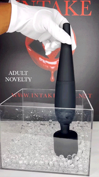 Black Magic Lick wand massager with INTAKE branding displayed in hand.