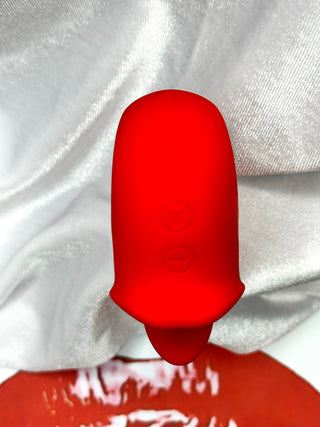 Close-up of Tongue Kiss dual-mode vibrator featuring realistic tongue tip and smooth red finish.