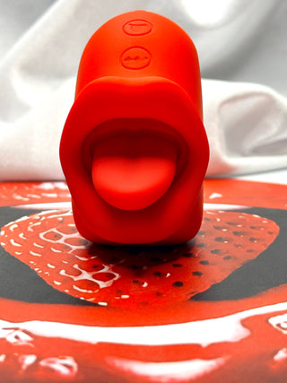 Front view of Tongue Kiss licking stimulator showing soft tongue design and control buttons.
